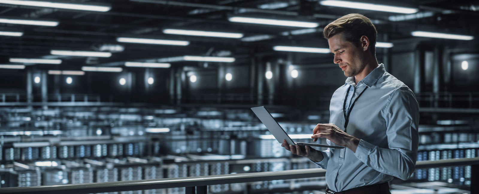 IT Specialist Uses Laptop in Data Center
