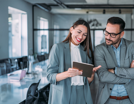 Two coworkers having a discussion in modern office