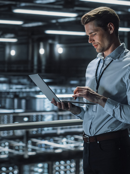 IT Specialist Uses Laptop in Data Center
