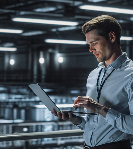 IT Specialist Uses Laptop in Data Center