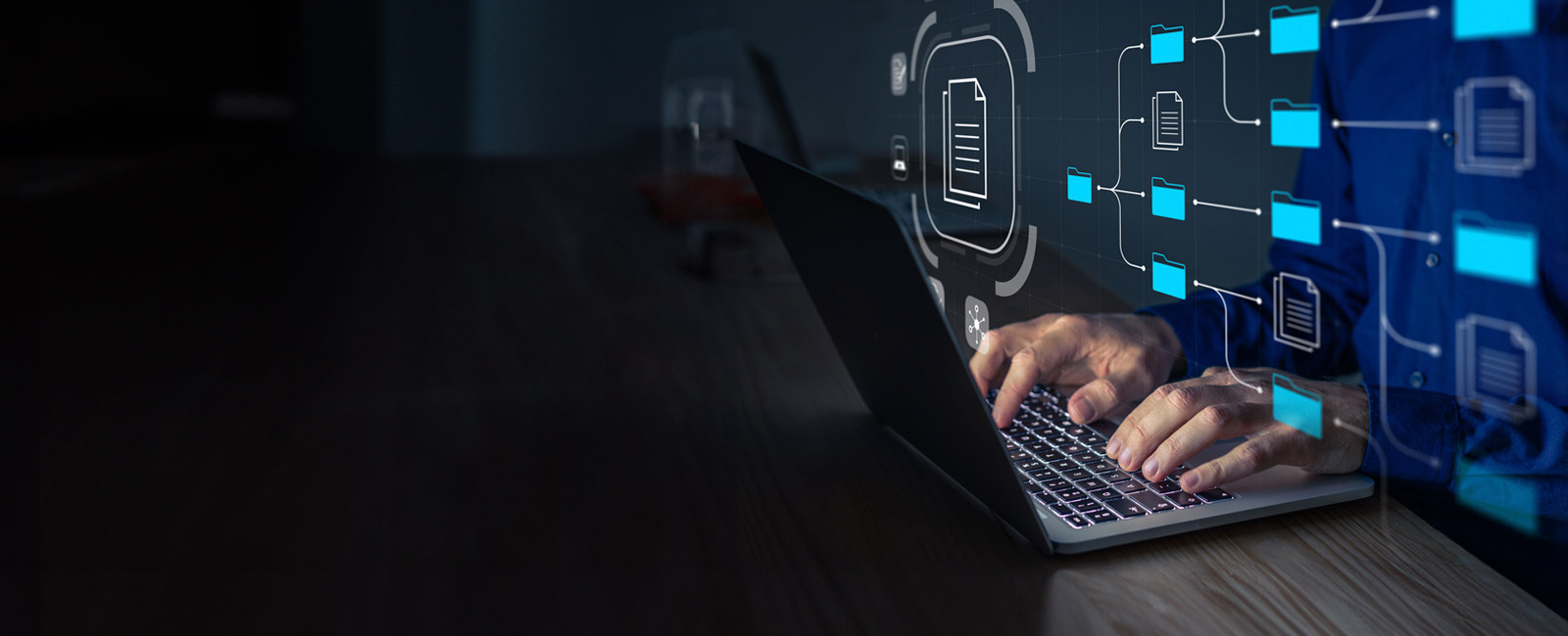 Man with a laptop managing corporate files and information