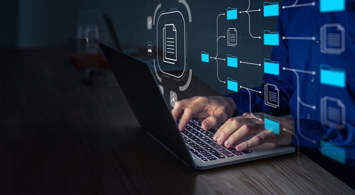 Man with a laptop managing corporate files and information