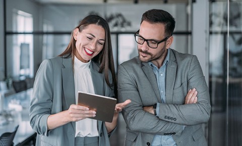 Two coworkers having a discussion in modern office