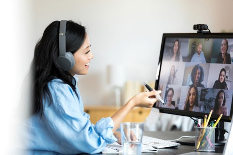 Teacher smiles and gestures while teaching an online class