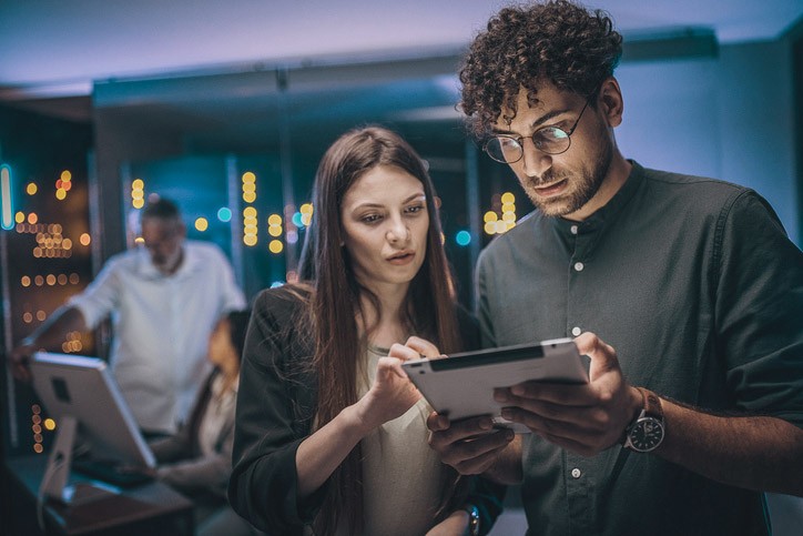Maintenance engineers examining data on digital tablet